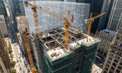 Aerial view of a high-rise construction site with digital twin overlay and real-time sensors.