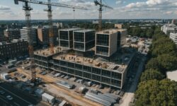 Aerial view of workers assembling prefabricated building components on a construction site.